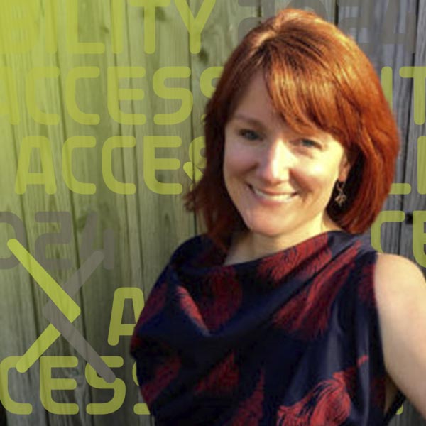 Headshot of Kim wearing a flowered shirt against a wooden wall