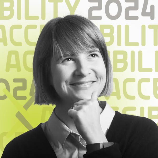 Black and white headshot of Mar smiling and looking thoughtfully upwards to the left while holding her chin