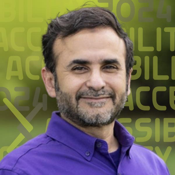 Headshot of Raafat Zaini in a purple shirt against a background of greenery