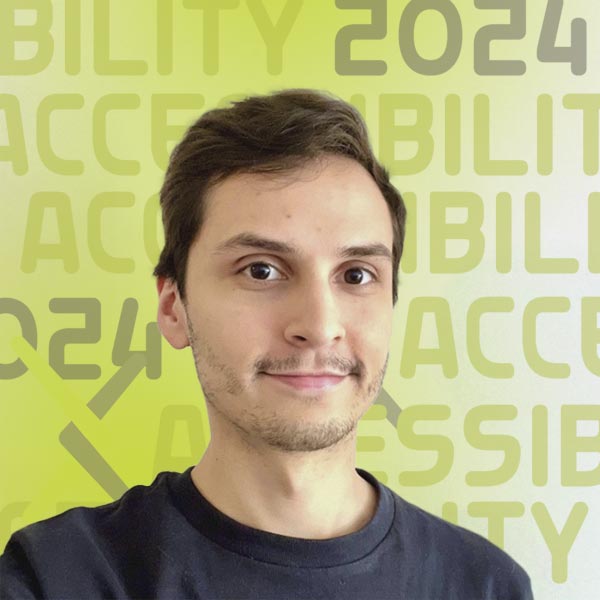 Headshot of Ricardo in a dark shirt against a light grey background