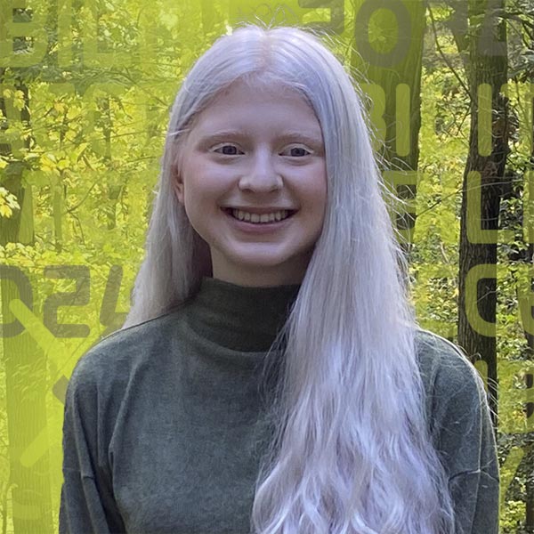 Headshot of Sarah Kane smiling in a forest