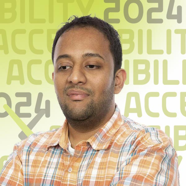 Headshot of Venkatesh in an orange plaid shirt against a white background